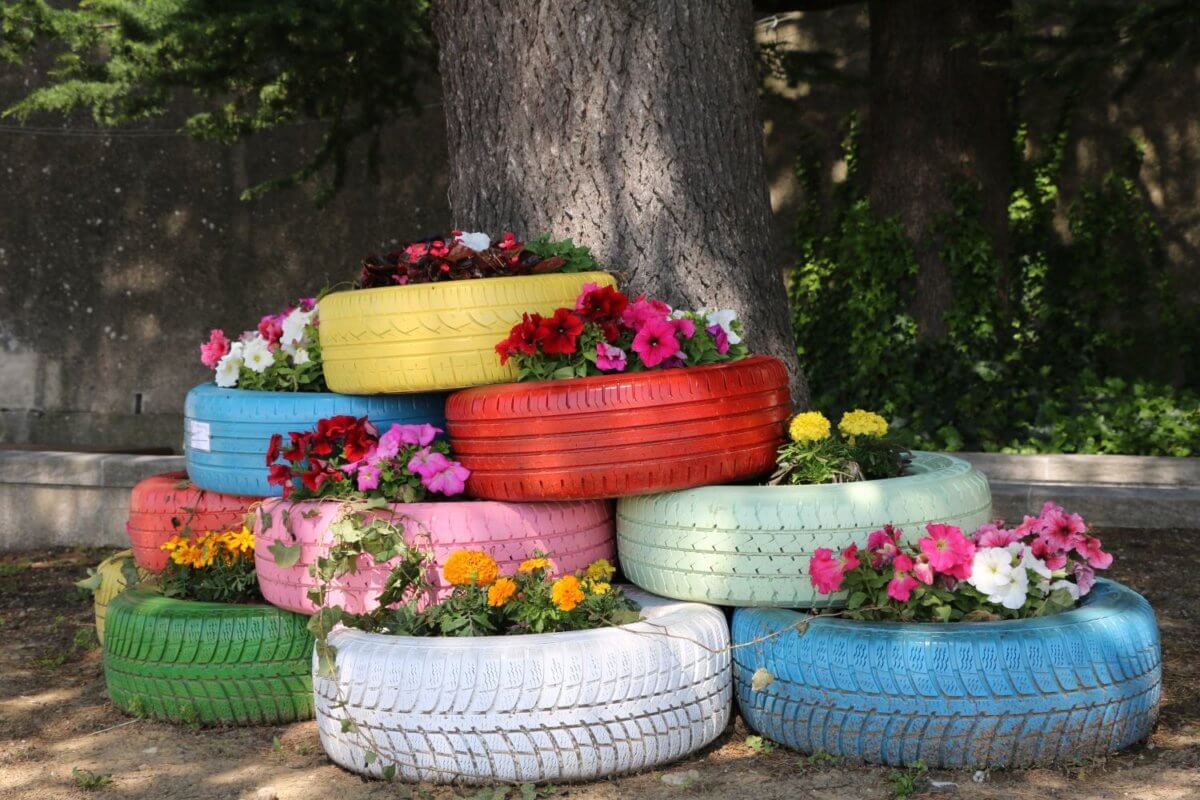 Bunte Autoreifen mit Blumen bepflanzt