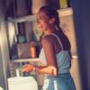 woman wearing white top /smiling inside garden shed