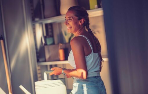 woman wearing white top /smiling inside garden shed